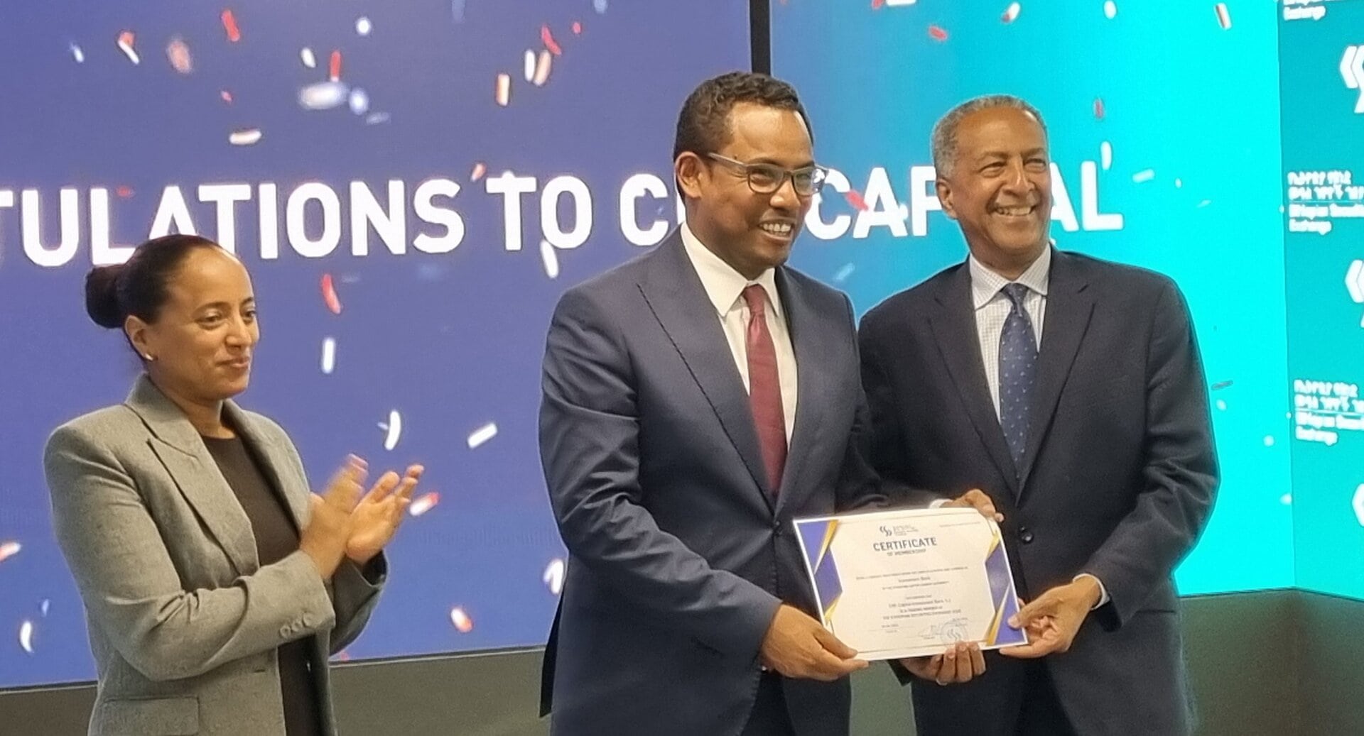 Three people celebrating CBE Capital investment bank joining the Ethiopian Securities Exchange as a stockbroker.