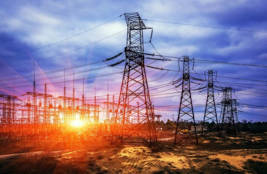 Powerlines at sunset highlight turbulent end for Umeme concession in Uganda.