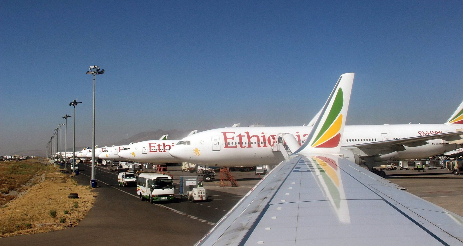 Many planes lined up on runway, illustrates innovative financing for Ethiopia new airport